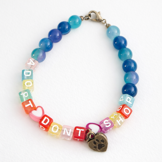 Colorful beaded bracelet with letter beads spelling 'DON'T ADOPT, DON'T SHOP' on a white background