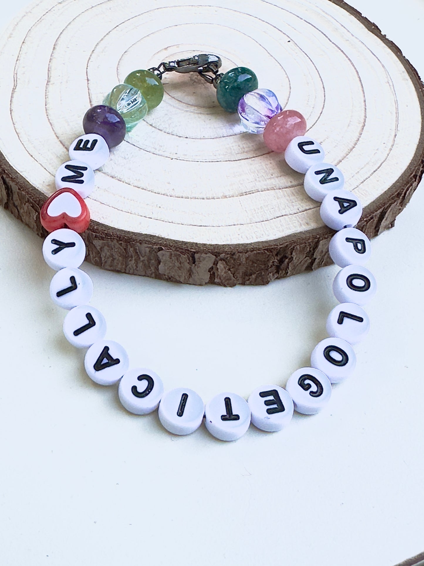 Unapologetically Me bracelet presented on a display stand highlighting handmade craftsmanship.