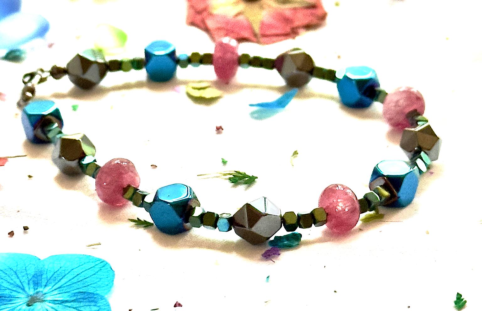 Handmade Afterglow gemstone bracelet shown from a slightly angled view with vibrant beads and decorative petals.