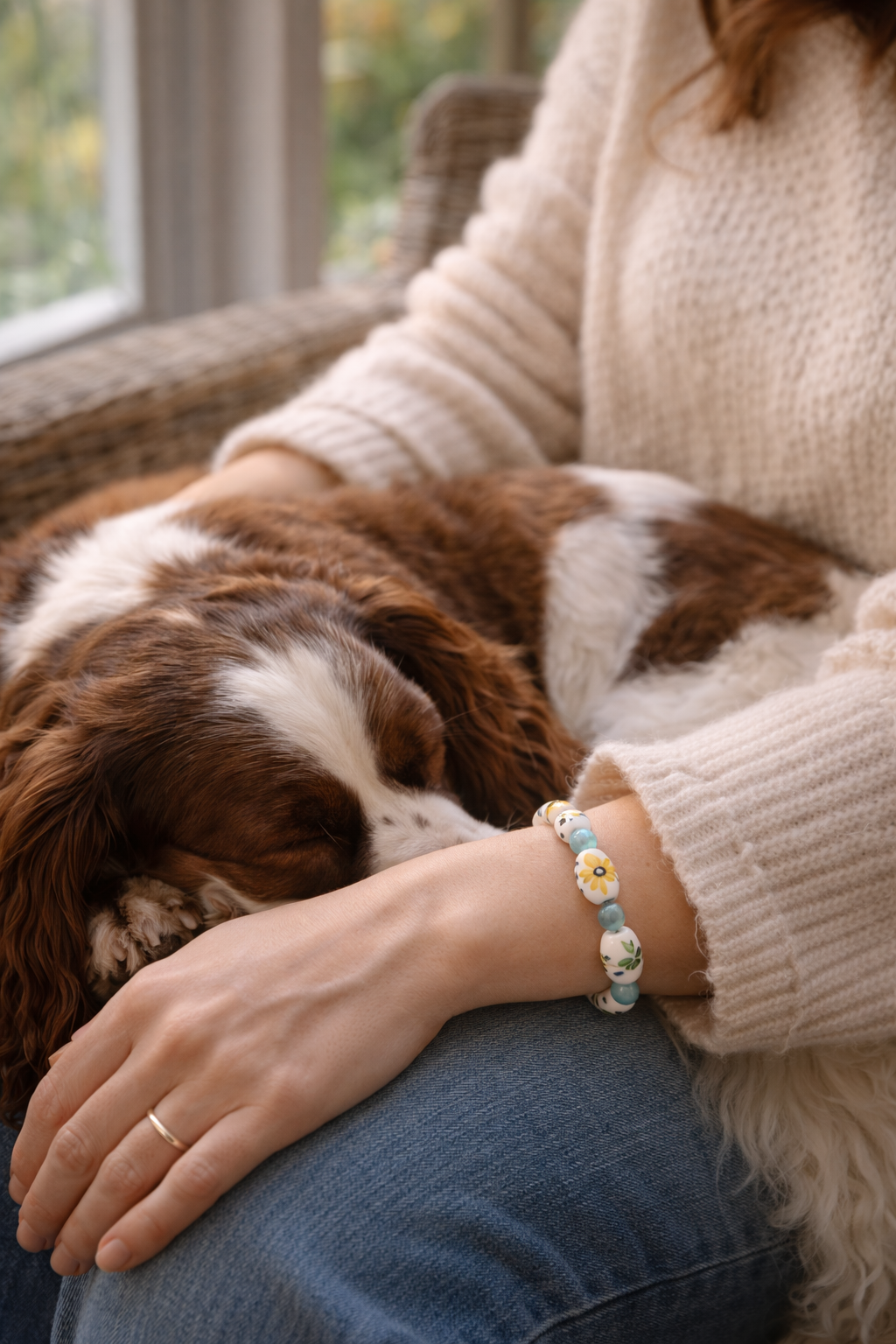 Handmade sunflower bracelet worn while cuddling a dog, cozy self care jewelry moment