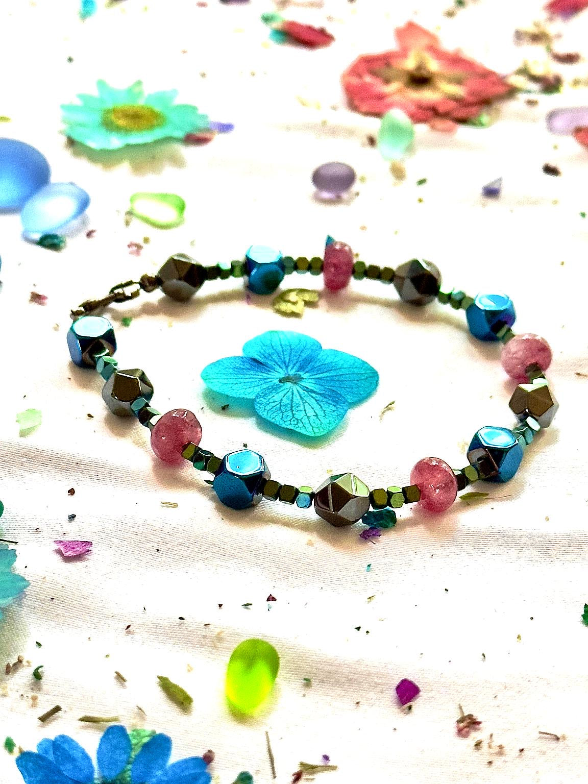 Detailed flat lay of the Afterglow bracelet with blue floral elements, showcasing its date night and girls night out style.