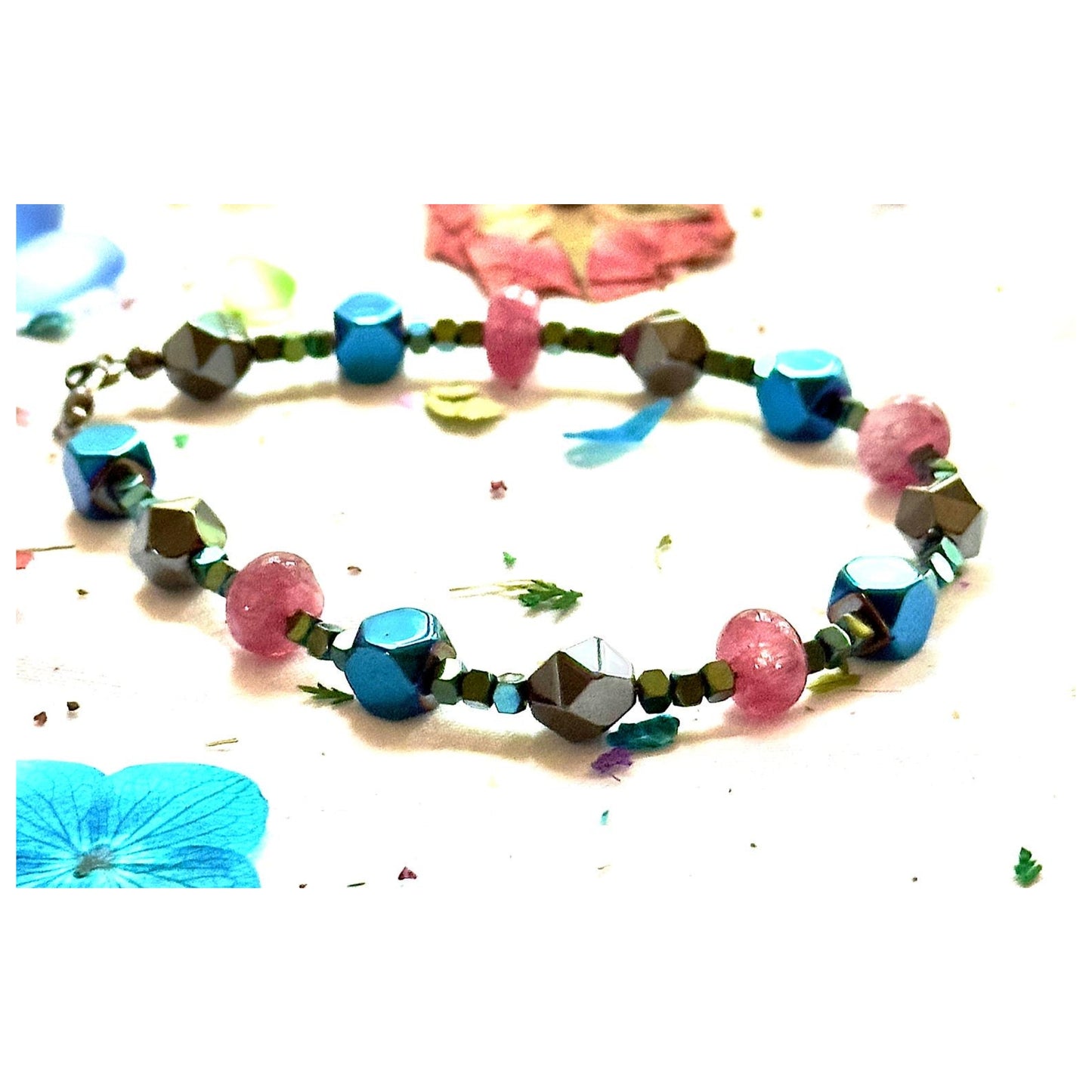 Handmade Afterglow gemstone bracelet shown from a slightly angled view with vibrant beads and decorative petals.