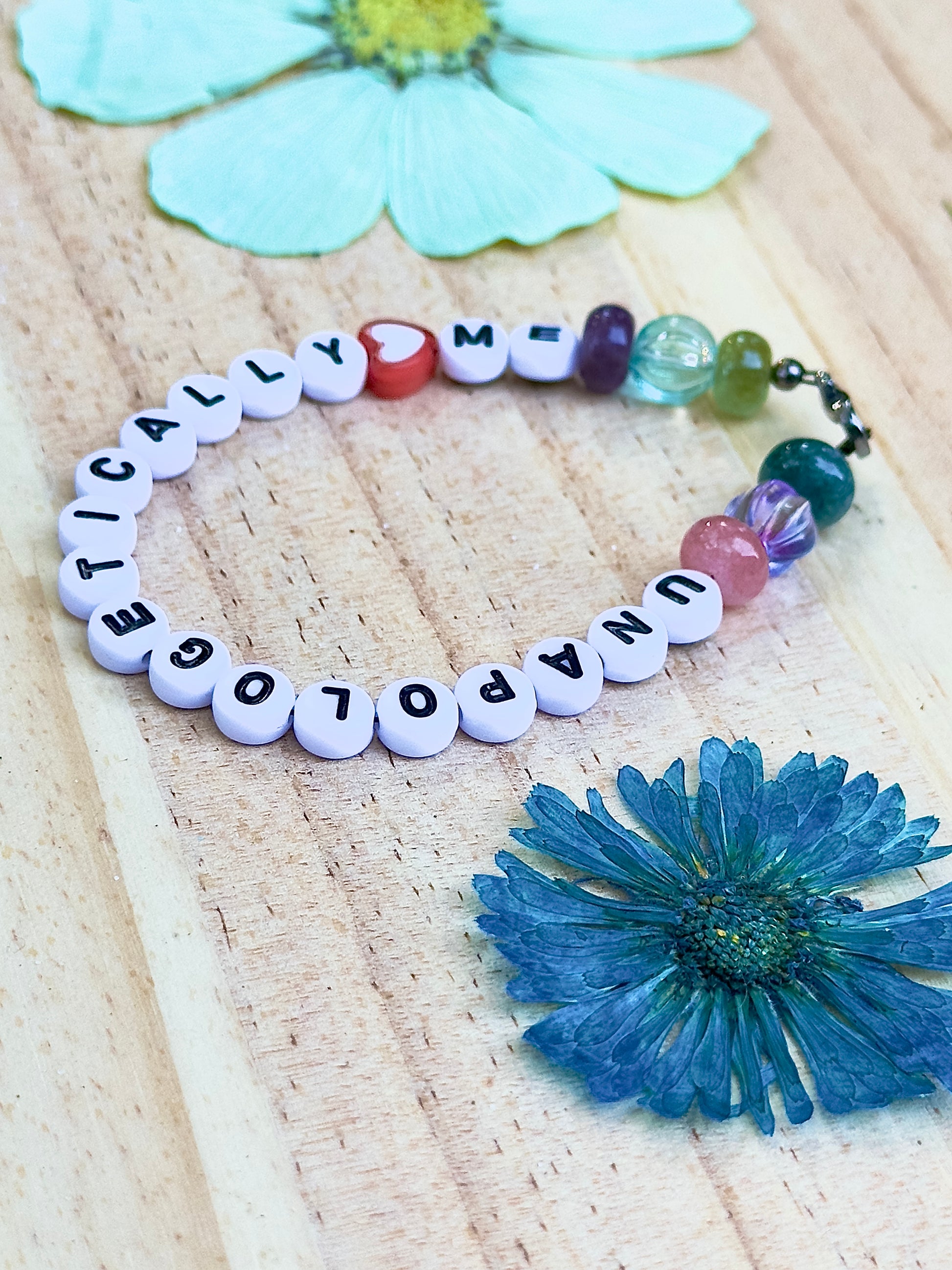 Detail shot of colorful gemstone beads and heart accent on an Unapologetically Me bracelet.