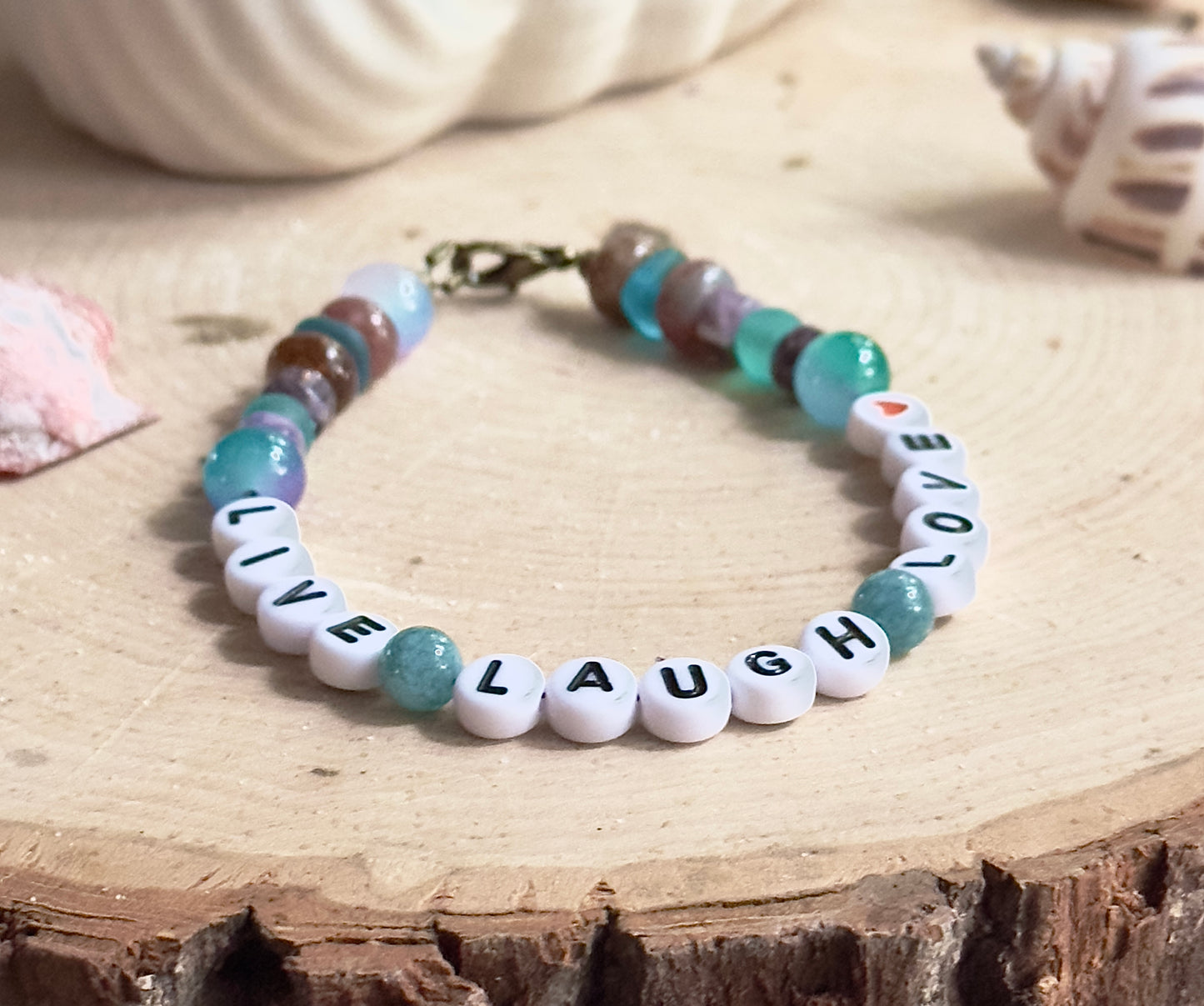 Live Laugh Love bracelet arranged in a relaxed circle to show full design, spacing, and bead pattern.
