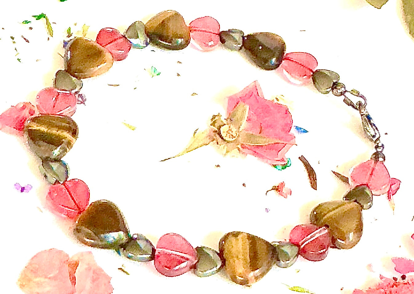 Close-up of Tiger Eye heart stones and pink glass heart beads on handmade gemstone bracelet