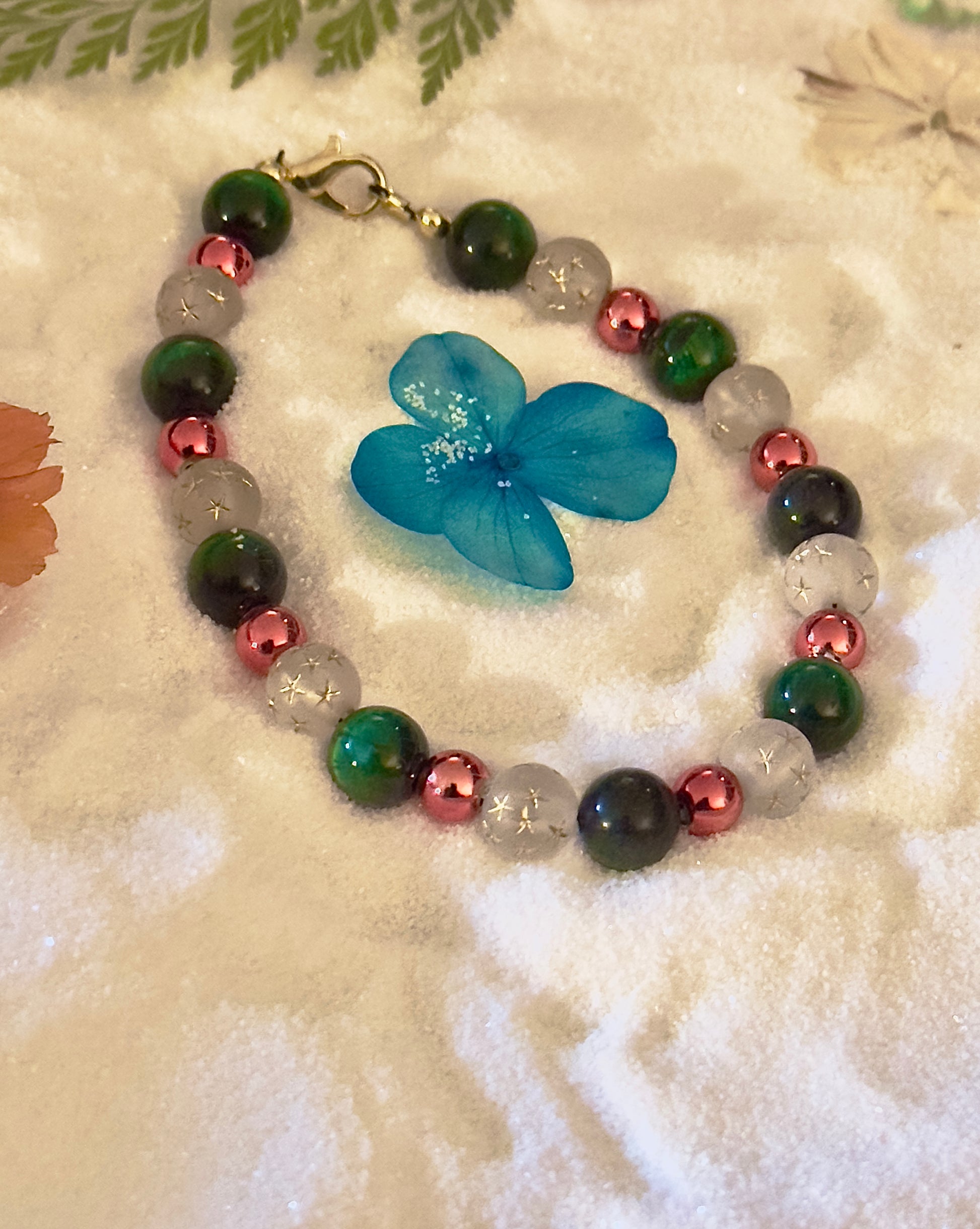 Holiday bracelet styled on a calm neutral surface with subtle seasonal accents for a peaceful, cozy finish.