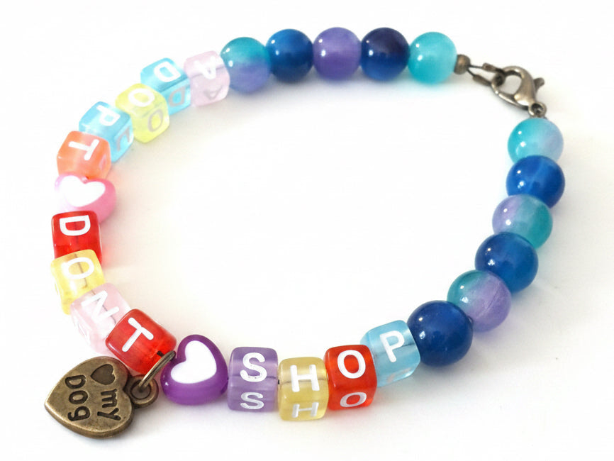 Handmade Adopt Don’t Shop bracelet shown from a different angle displaying colorful beads and pet adoption message.