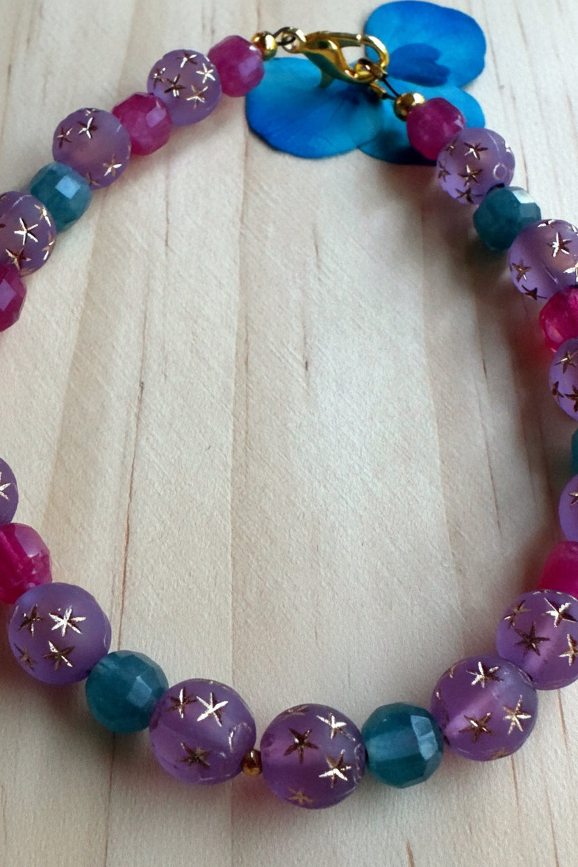 Close up of Aurora Goddess gemstone bracelet with pink purple and blue beads