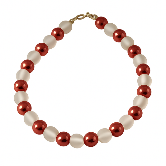 Handmade blush glass bead bracelet with rose-tone metallic accents arranged in a circle on a light textured background.