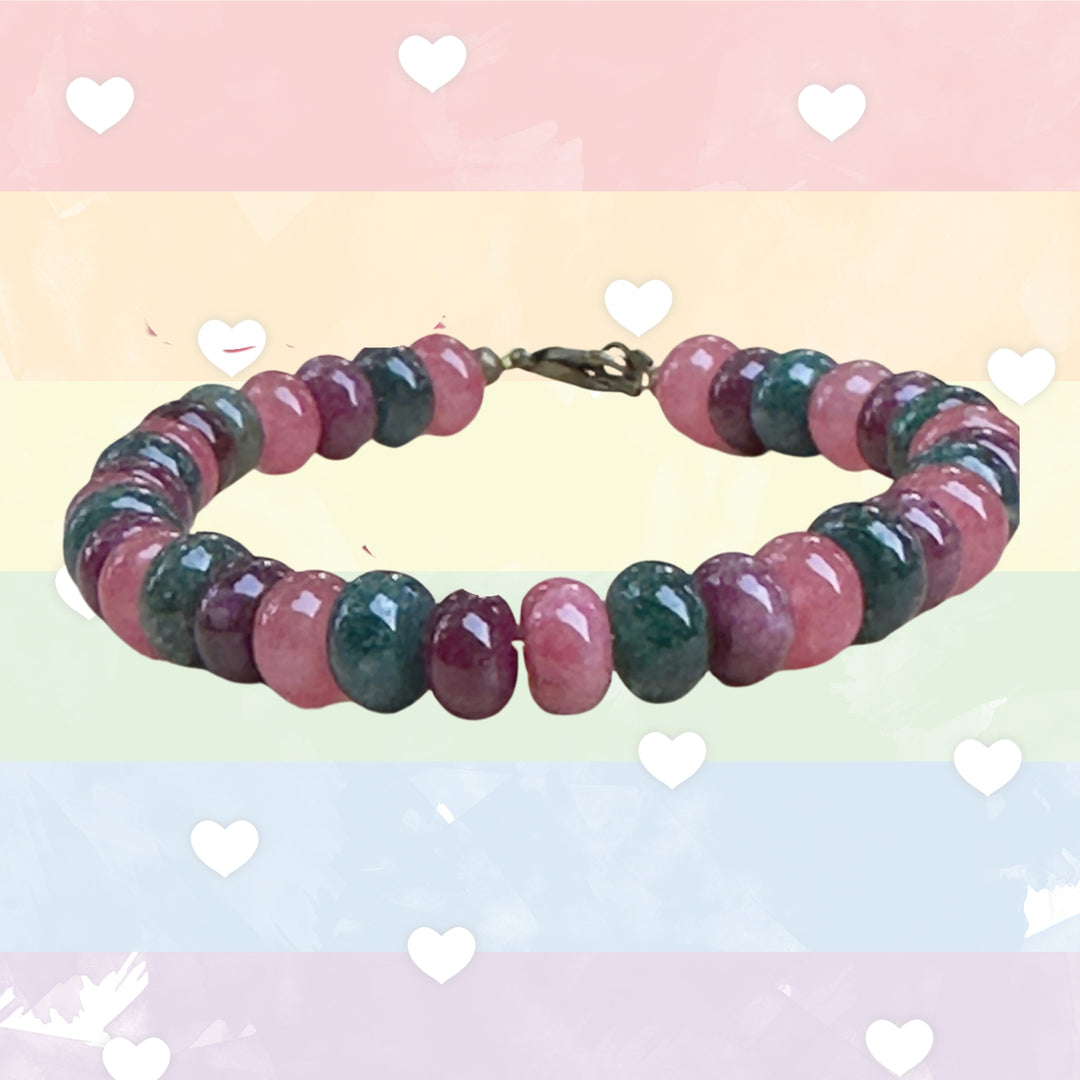 Multicolored beaded bracelet on a pastel background with heart shapes