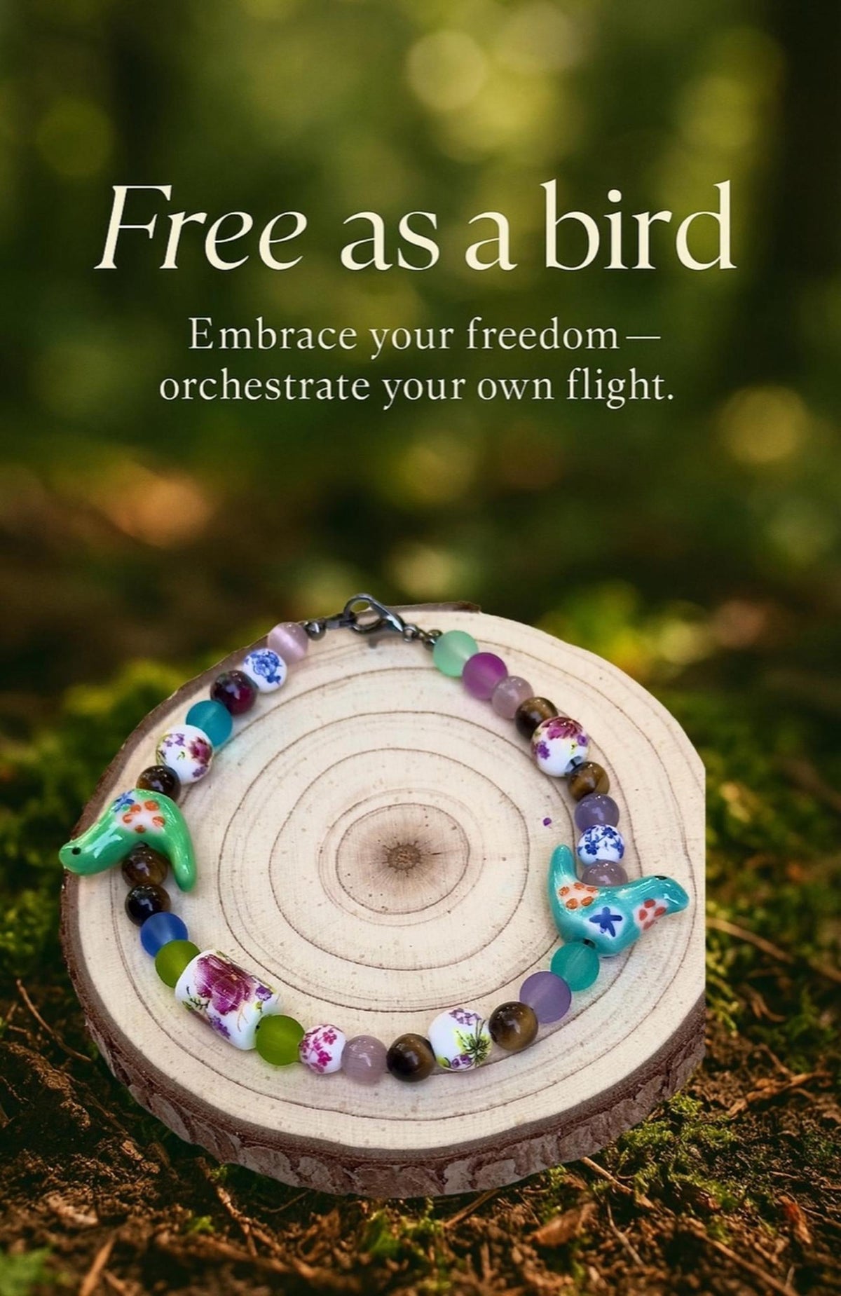 Bird-Eye View bracelet displayed outdoors on a wood slice with a nature-inspired quote and soft green woodland background.