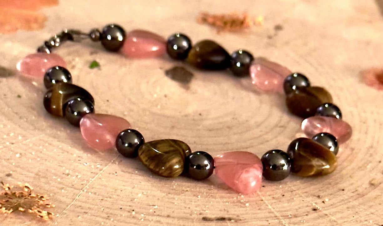 Rose quartz and tiger's eye bracelet displayed on a soft neutral background highlighting self-love inspired jewelry.