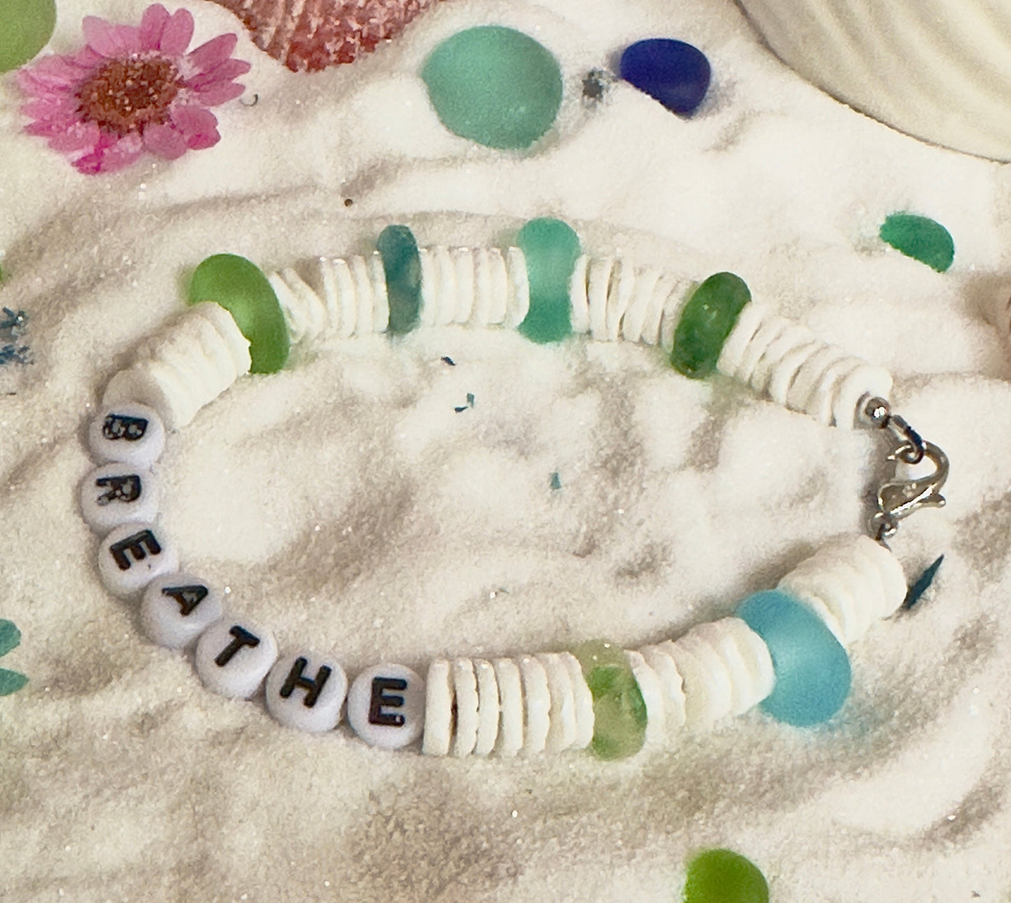 Beach inspired Breathe bracelet styled in sand with shells and soft coastal tones