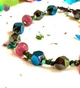Close-up of the Afterglow gemstone bracelet highlighting teal, green, and blush beads with silver clasp details.