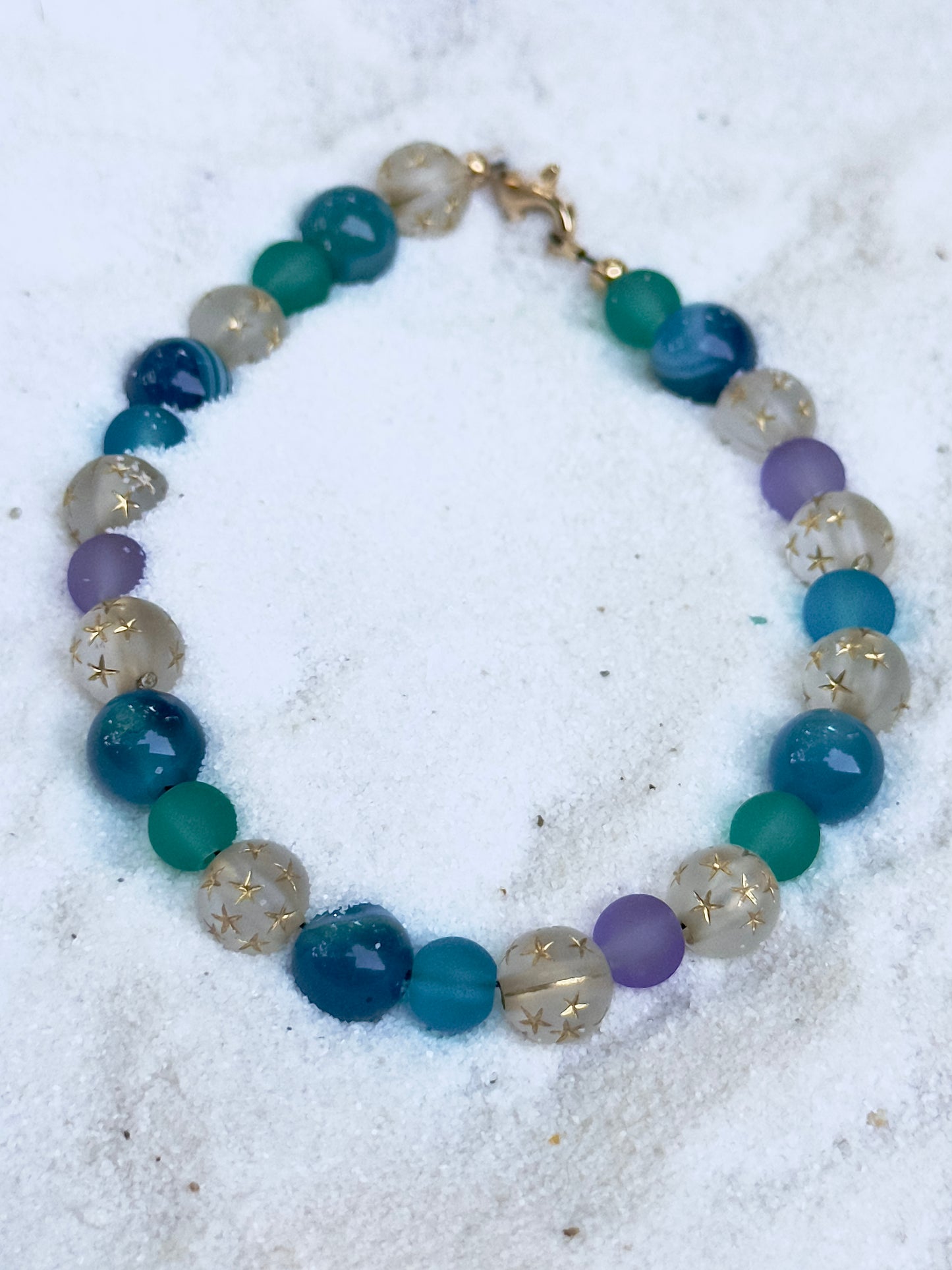 Close-up of Celestial Opalite Sky bracelet beads showing opalite shimmer, blue tones, and star-pattern accents
