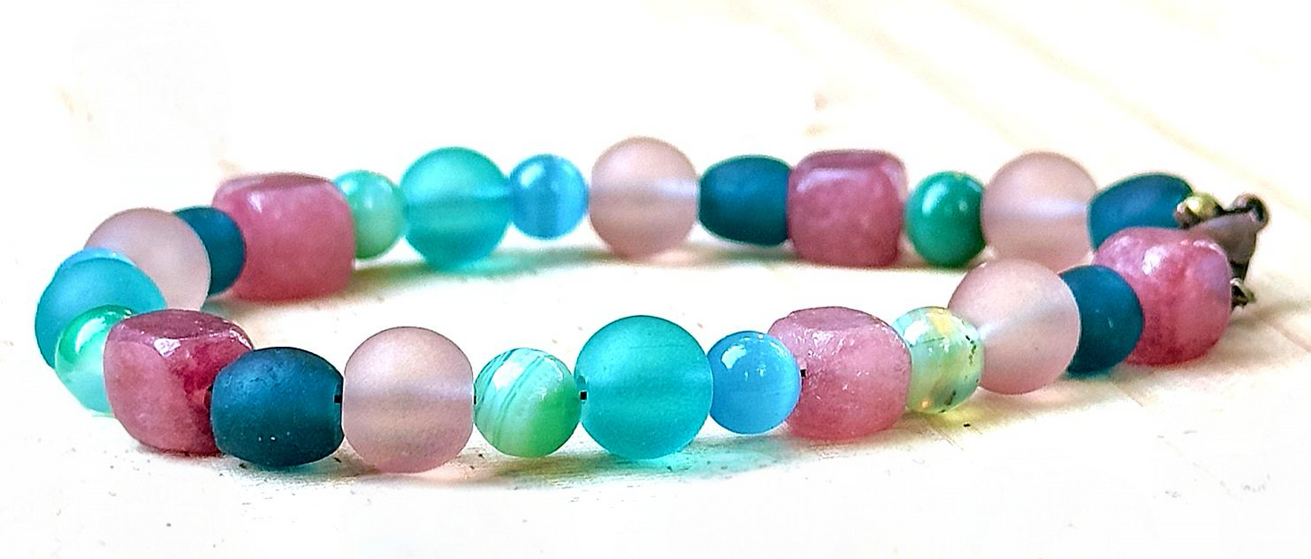 close up of pink jade and frosted teal beads showing texture handmade bracelet detail