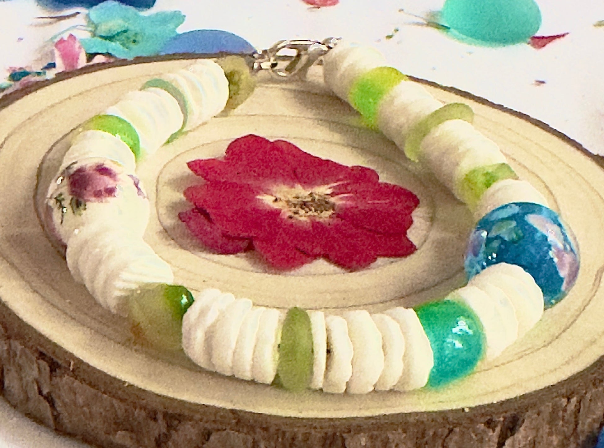 Coastline Oasis bracelet is displayed with flowers, shells, and coastal-inspired accessories.