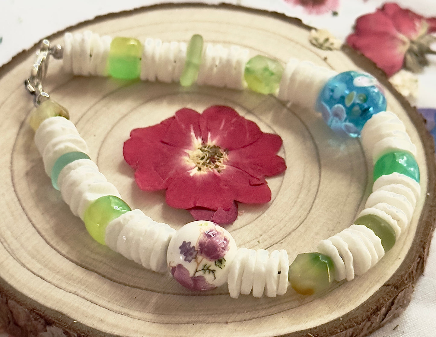 Handmade Spring Garden Serenity bracelet featuring white heishi beads and floral focal beads.