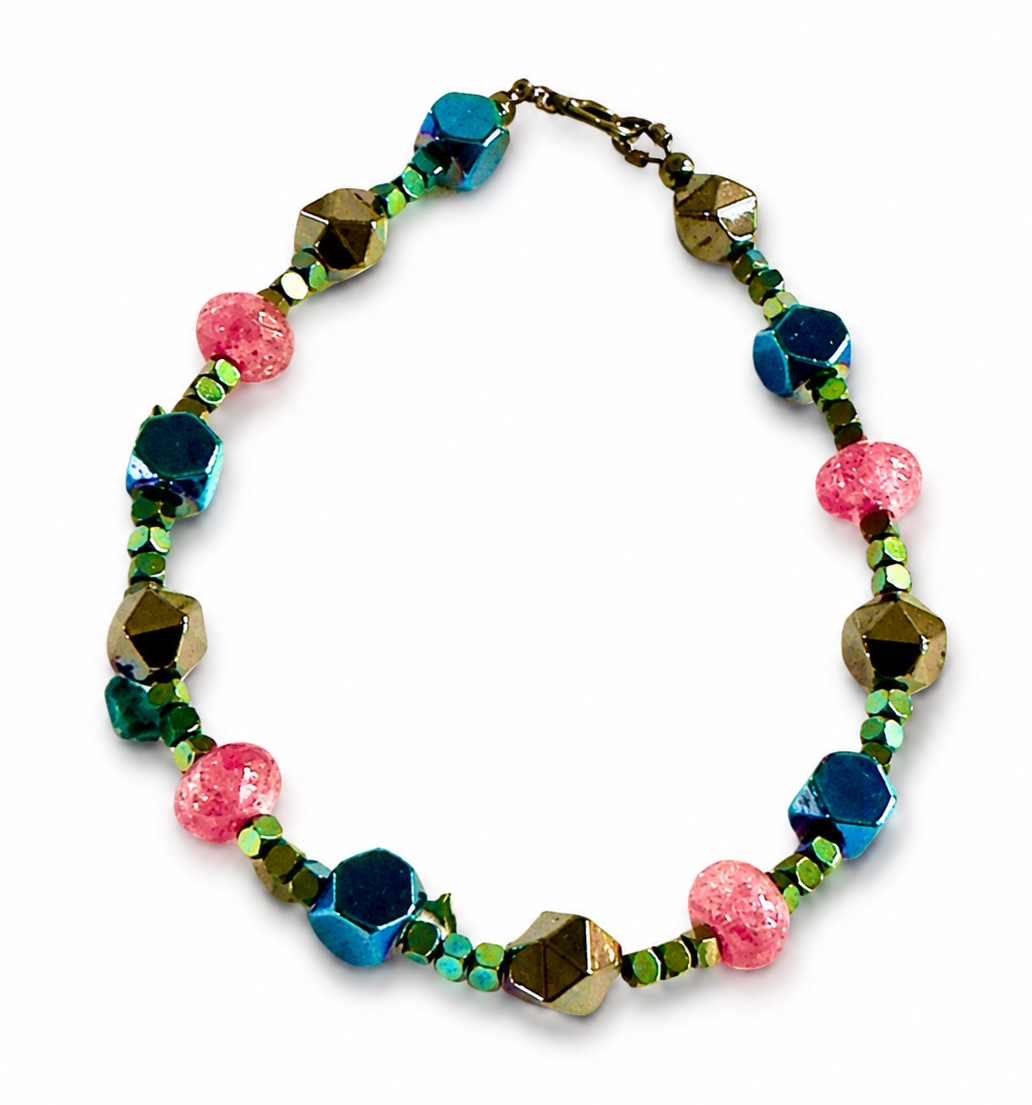 Colorful handmade Cosmic Lagoon bracelet with blue pink and metallic beads on white background