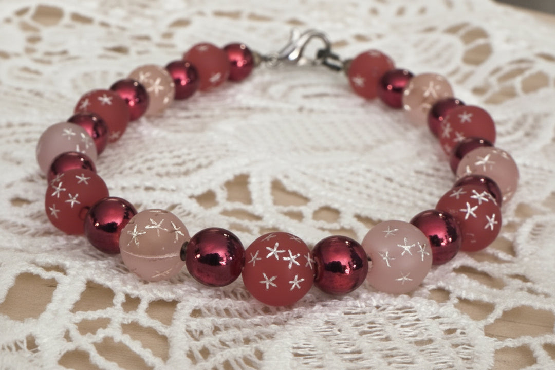     Electric Cosmic Skies whimsical beaded bracelet displayed on vintage lace fabric with pink and red shimmer beads