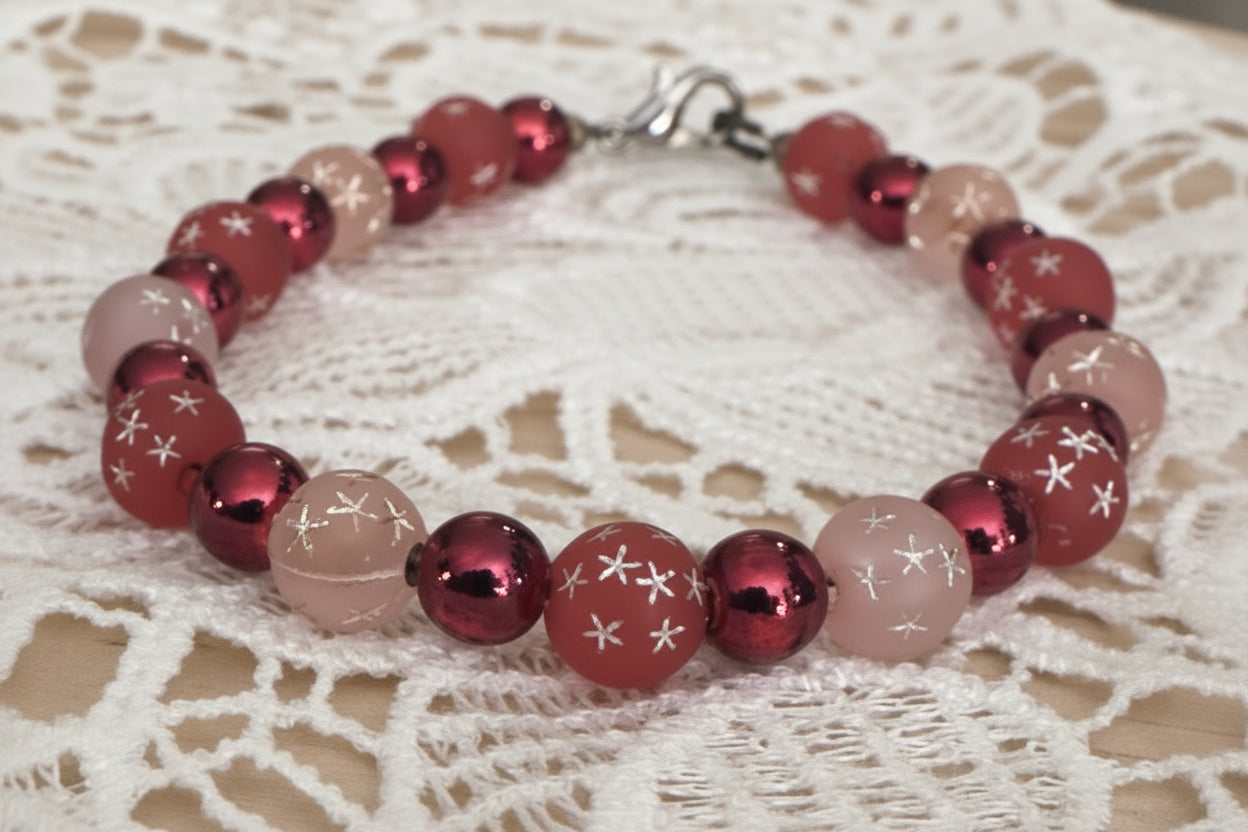     Electric Cosmic Skies whimsical beaded bracelet displayed on vintage lace fabric with pink and red shimmer beads
