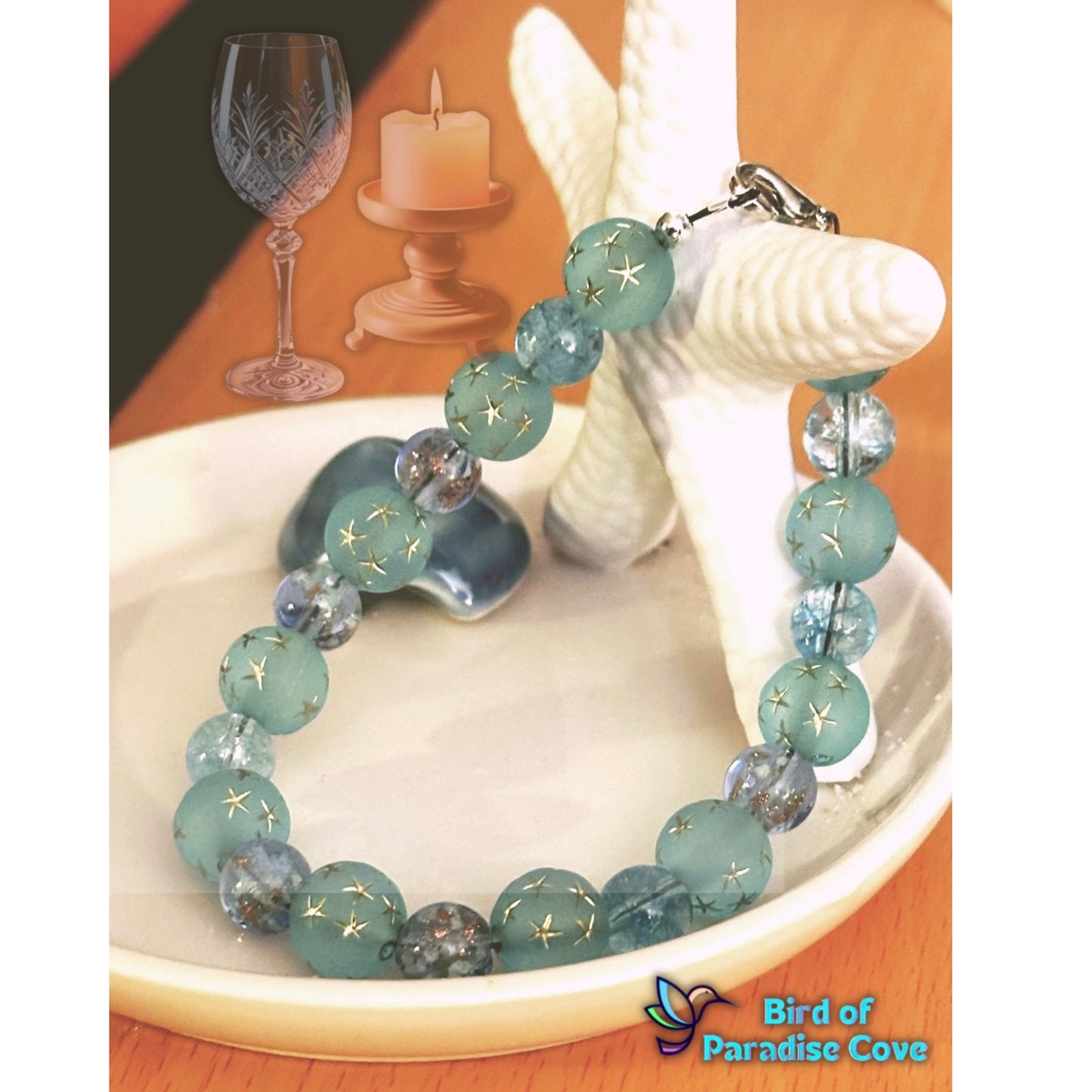Blue and teal beaded bracelet arranged on sand with sea glass and soft lighting for a calm coastal aesthetic
