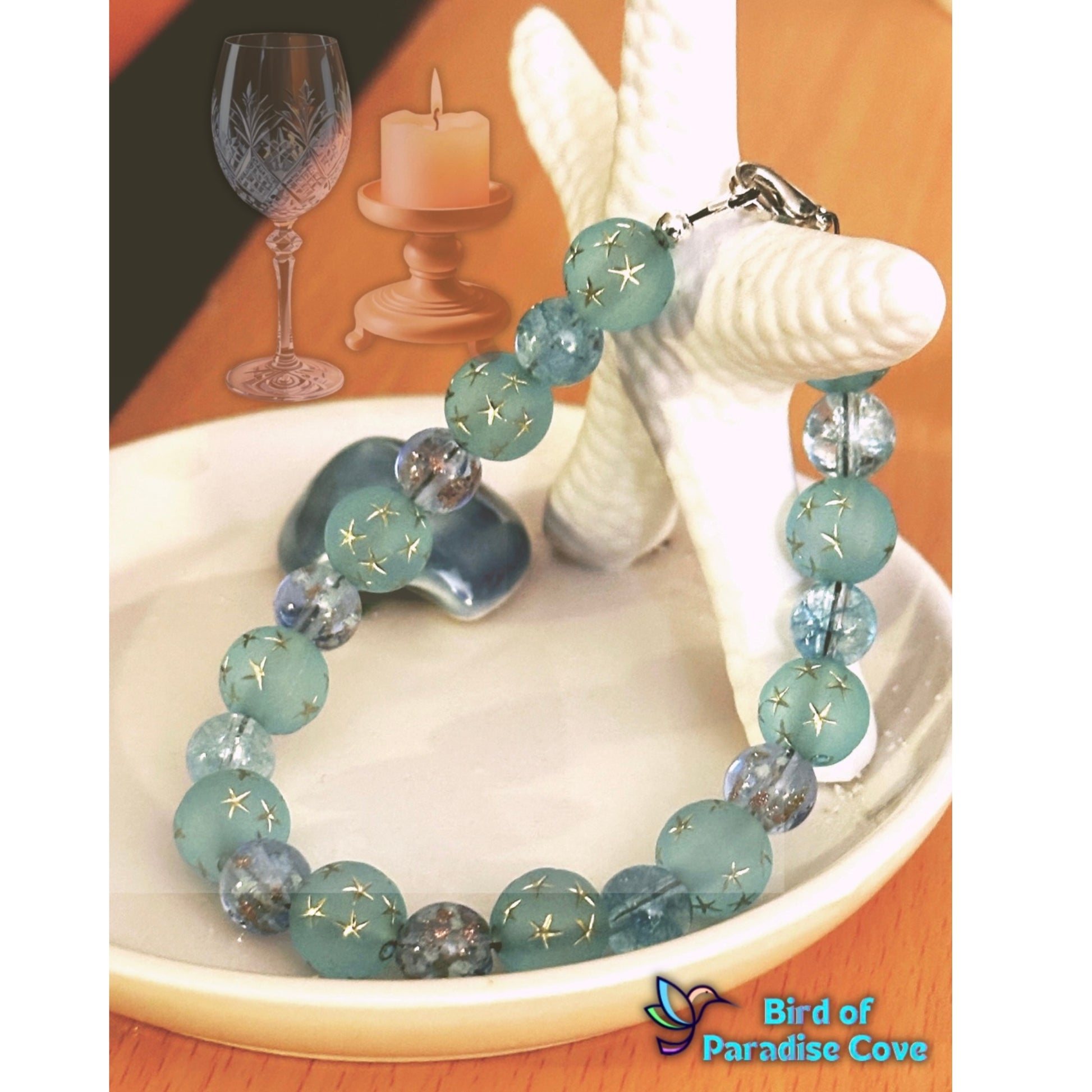 Blue and teal beaded bracelet arranged on sand with sea glass and soft lighting for a calm coastal aesthetic