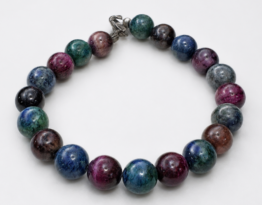 Colorful gemstone bracelet with blue, teal, purple, and magenta beads on white background