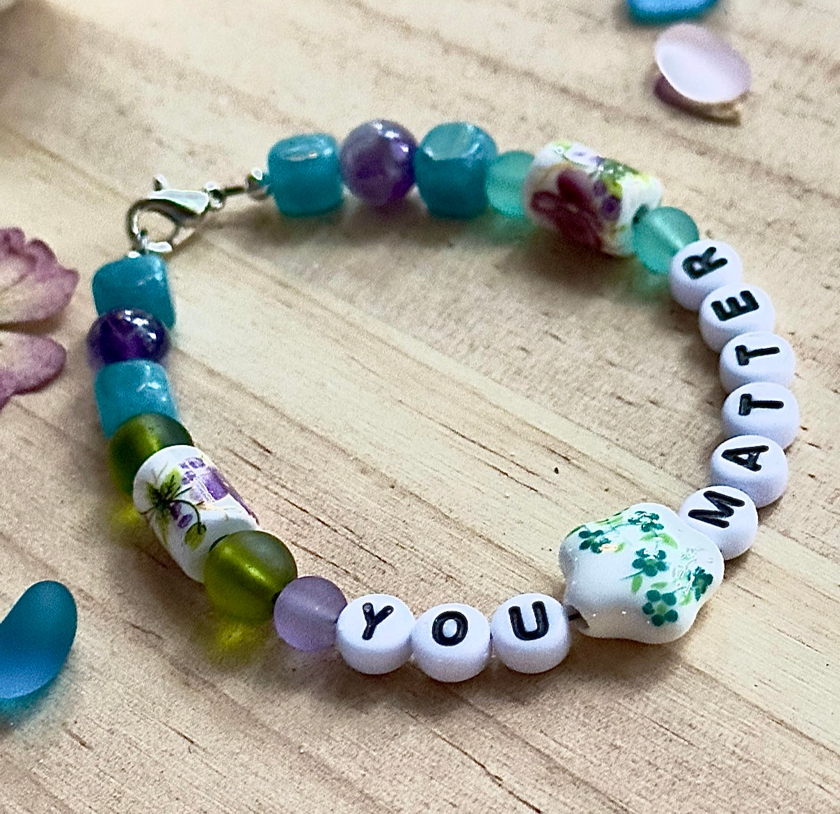 
Flat lay of a handmade “You Matter” bracelet styled in natural light, reflecting calm, mindfulness, and self-care.
