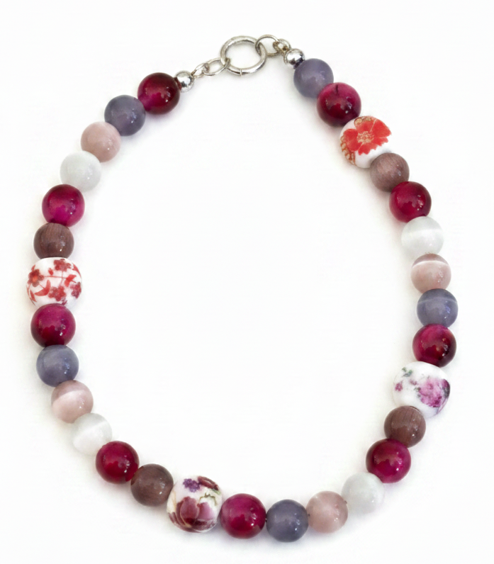 Multicolored beaded bracelet with floral patterns on a white background