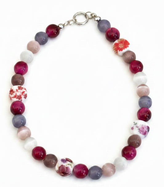 Multicolored beaded bracelet with floral patterns on a white background