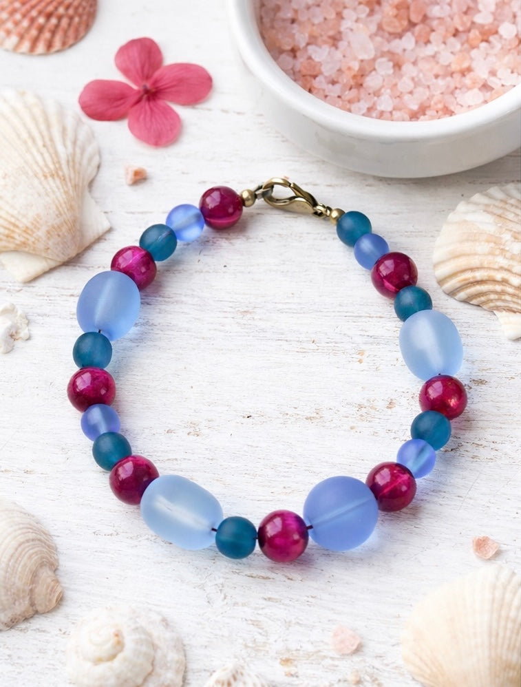 Circular view of a blue and pink beaded bracelet showing full design, bead pattern, and lobster clasp closure.