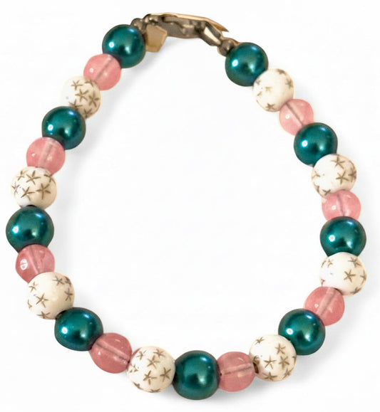 Galaxy pink teal beaded bracelet with star accent beads on white background