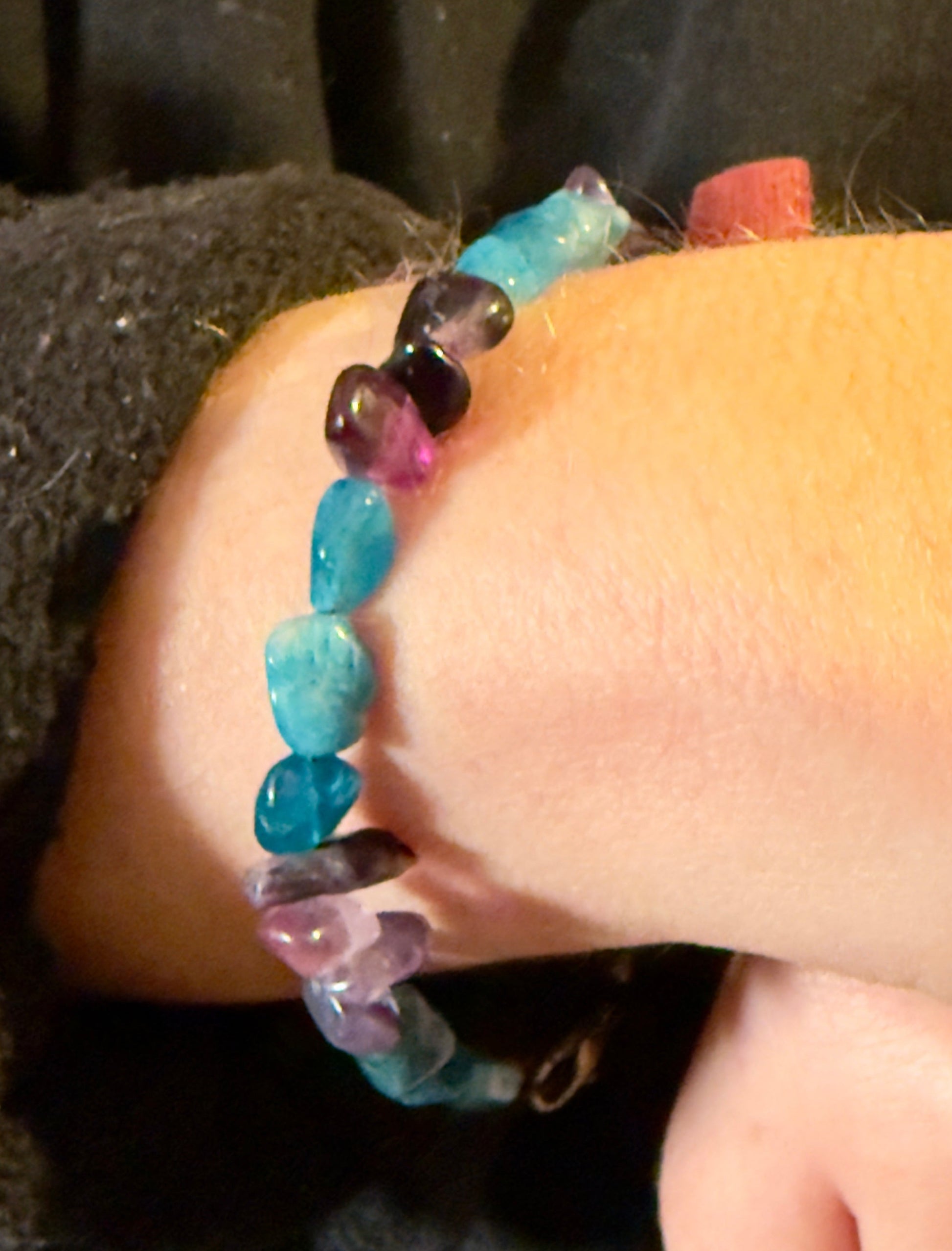     Blue Apatite and Amethyst mental health awareness bracelet worn on wrist in warm natural lighting