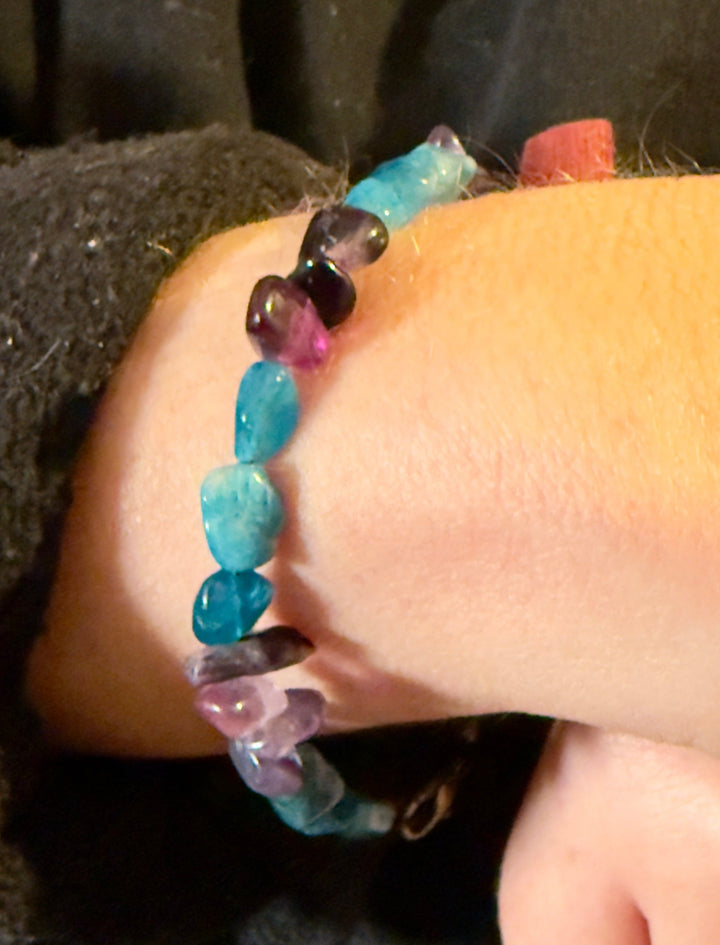     Blue Apatite and Amethyst mental health awareness bracelet worn on wrist in warm natural lighting