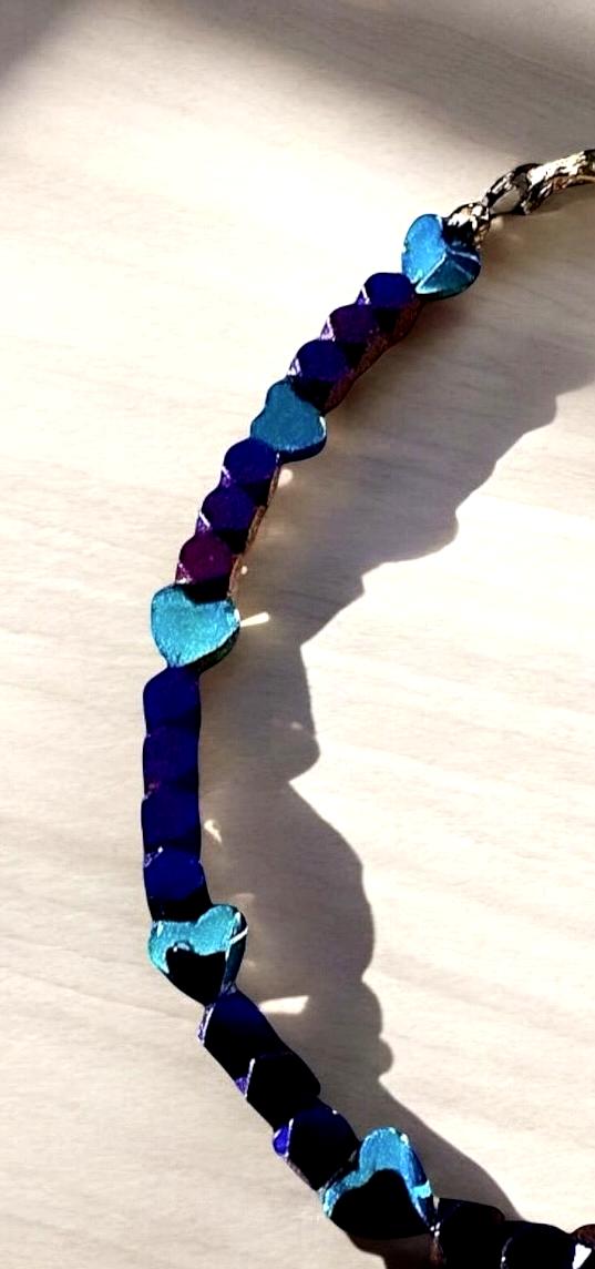 Heartspell Twilight bracelet photographed in natural light with dramatic shadows highlighting its purple, blue, and turquoise beads.