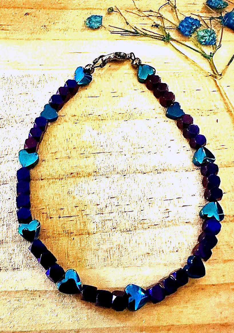 Heartspell Twilight bracelet photographed in natural light with dramatic shadows highlighting its purple, blue, and turquoise beads.