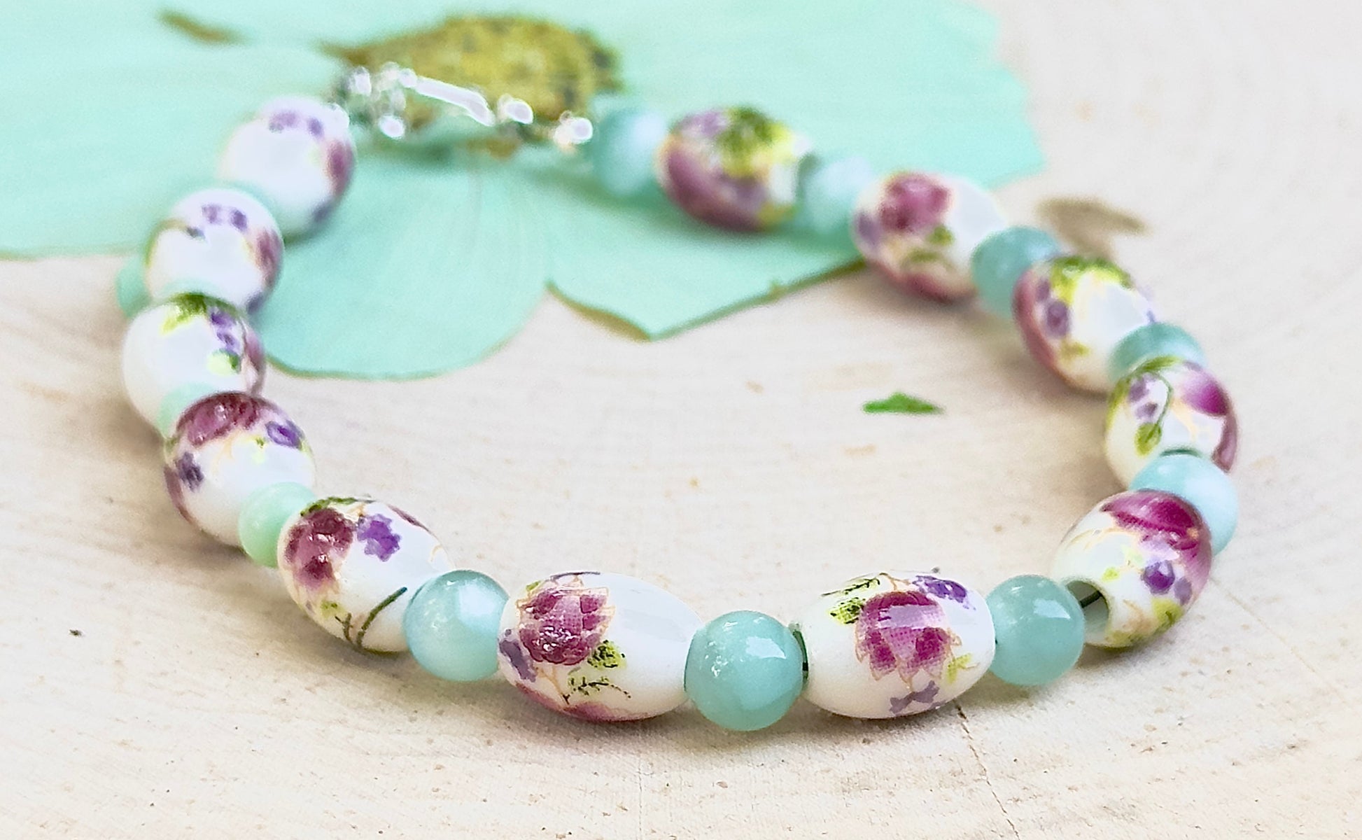 Full view of Hidden Reverie Meadow bracelet featuring porcelain floral beads inspired by wildflower meadows.