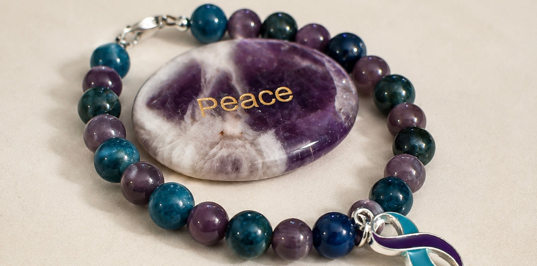 Close-up of handmade awareness bracelet with polished amethyst Peace stone and silver awareness ribbon charm.