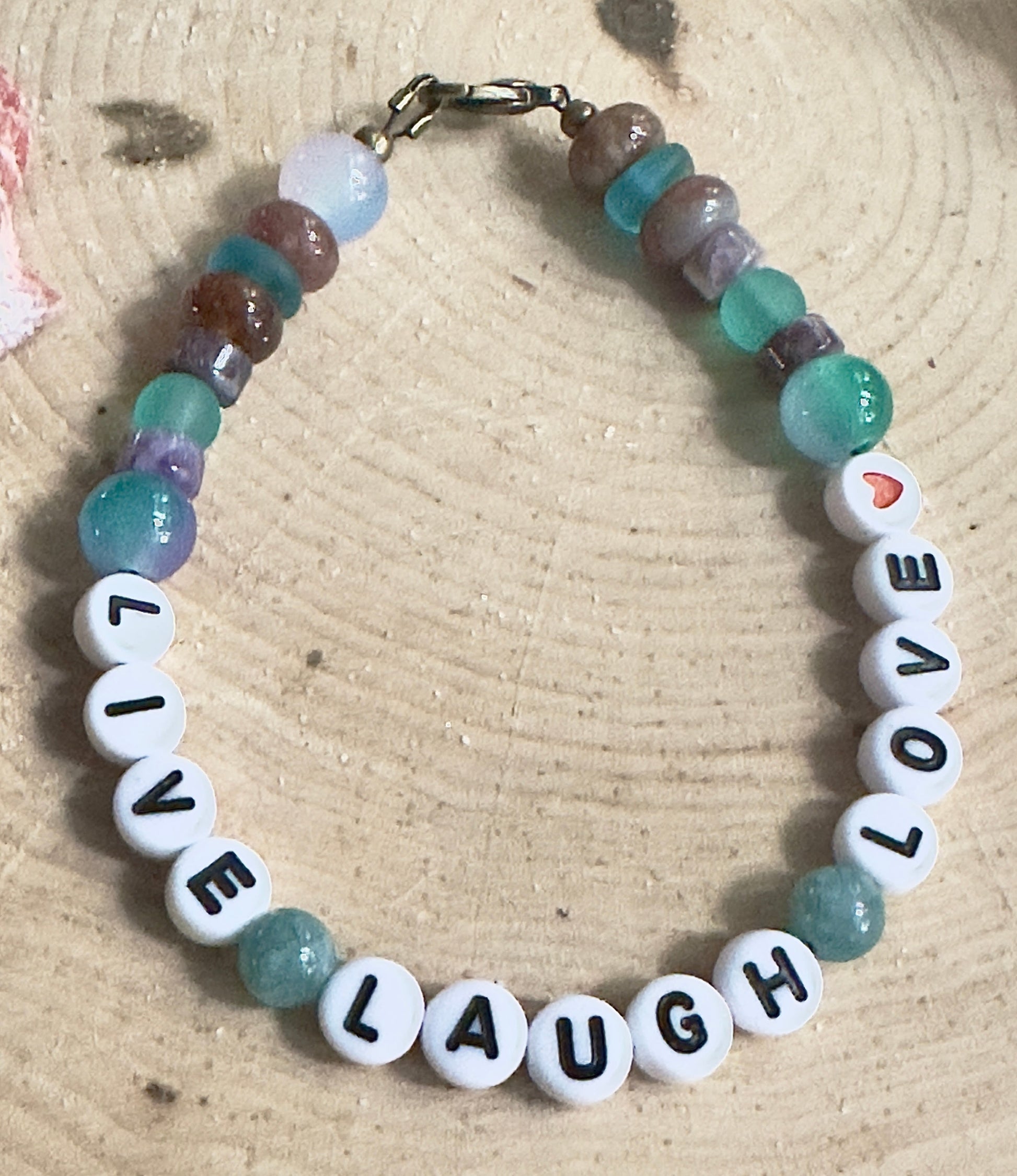Bracelet with motivational beads on a wooden surface