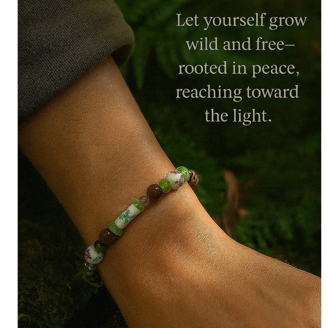 Meadowlight Garden of Stillness bracelet worn on the wrist in a peaceful green nature setting.