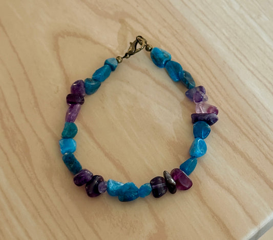 Amethyst and Amazonite gemstone bracelet on light wood background with lobster clasp closure