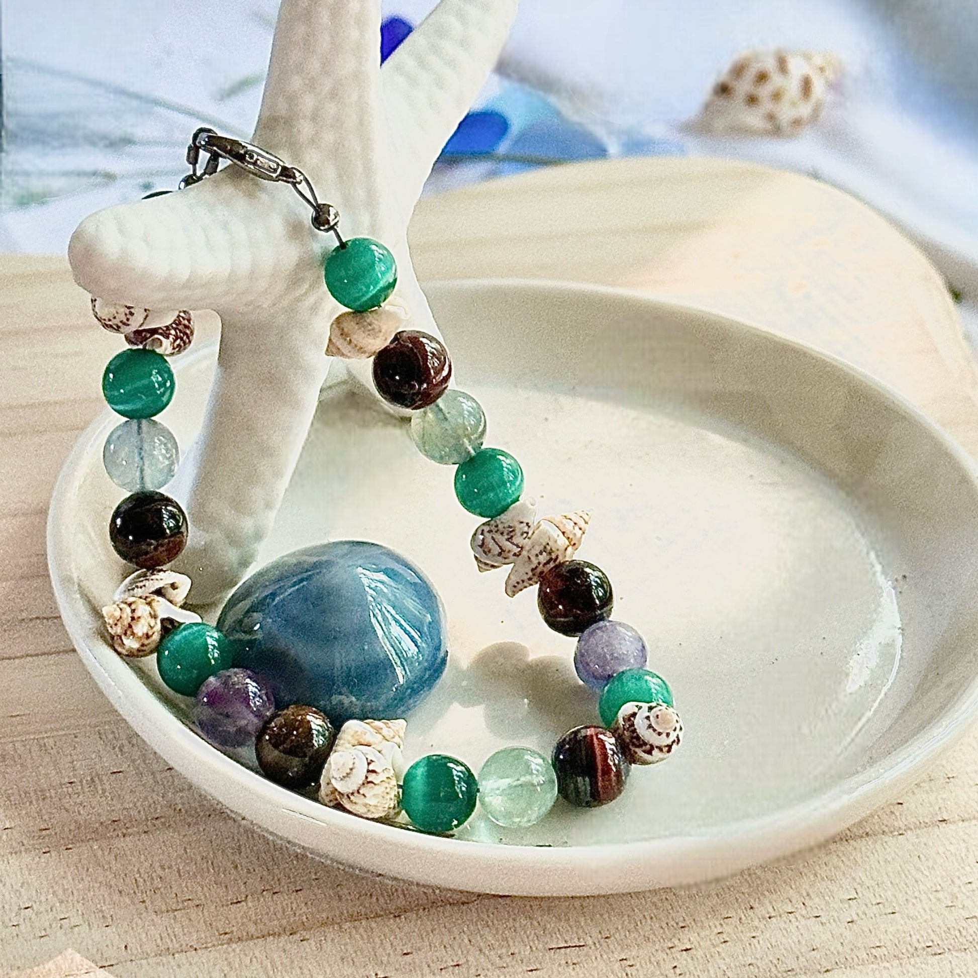 Ocean’s Treasure bracelet styled in a decorative coastal bowl with ocean-inspired accents.