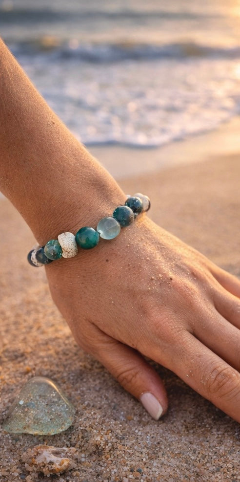 Ocean’s Treasure ocean-inspired bracelet worn on a wrist at the beach during golden hour.