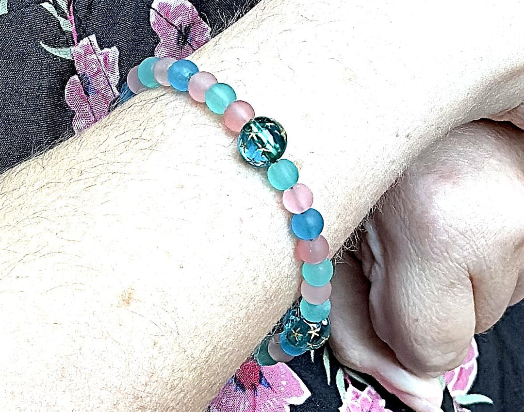 teal and pink gemstone bracelet worn on wrist calming beaded bracelet for emotional balance and everyday wear