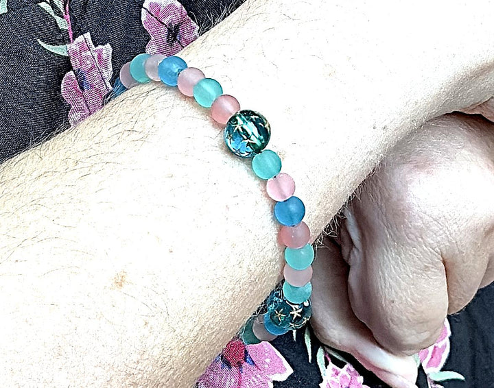 teal and pink gemstone bracelet worn on wrist calming beaded bracelet for emotional balance and everyday wear