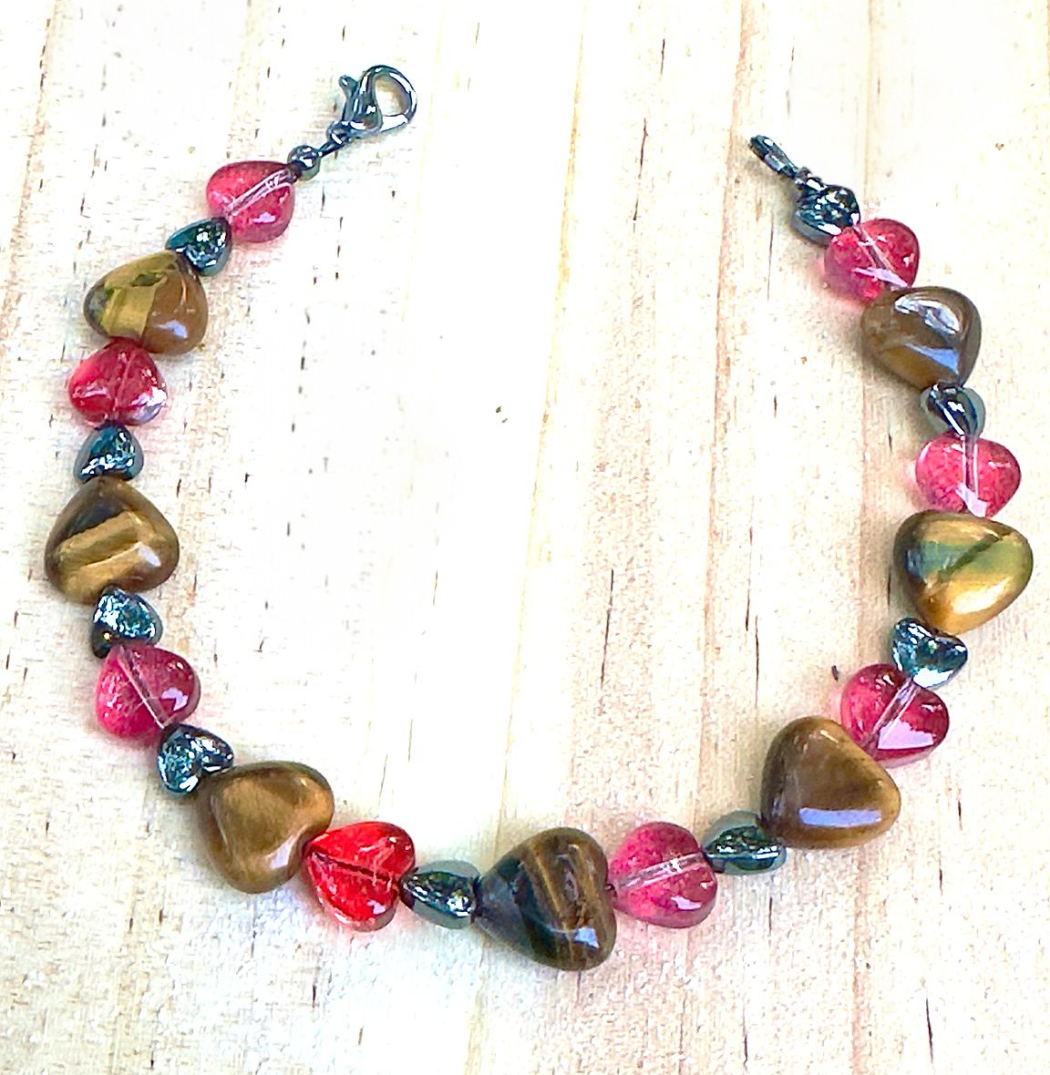 Colorful beaded bracelet on a light wooden surface