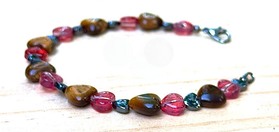 Multicolored beaded bracelet on a light wooden surface
