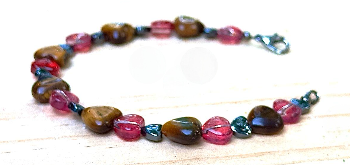 Multicolored beaded bracelet on a light wooden surface