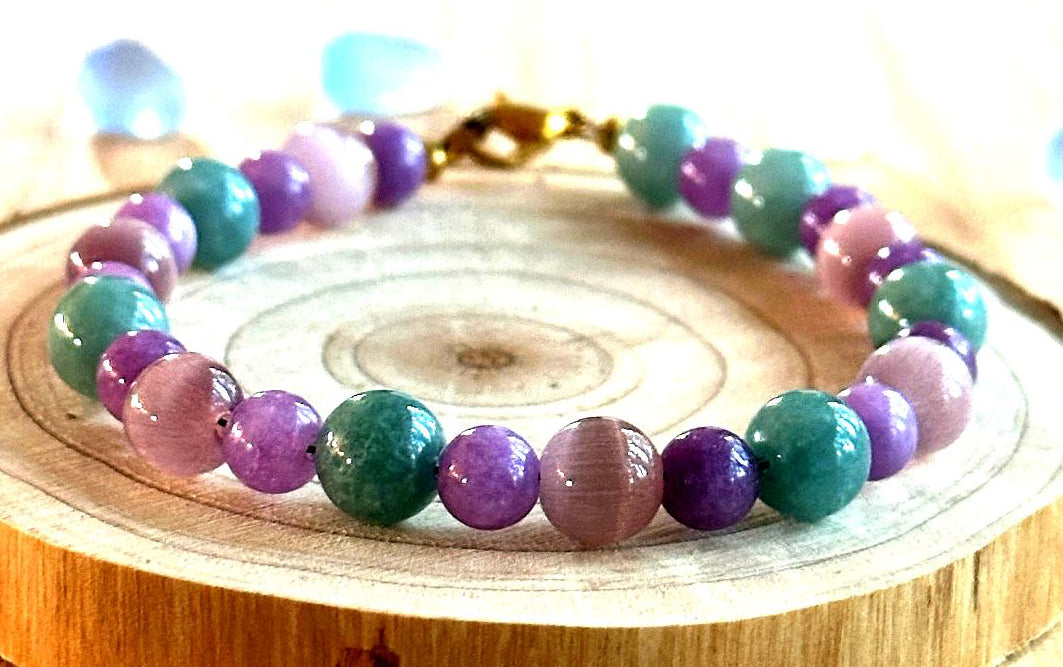Spring Garden Serenity nature inspired bracelet displayed on a wood showcasing soft pastel gemstone beads.